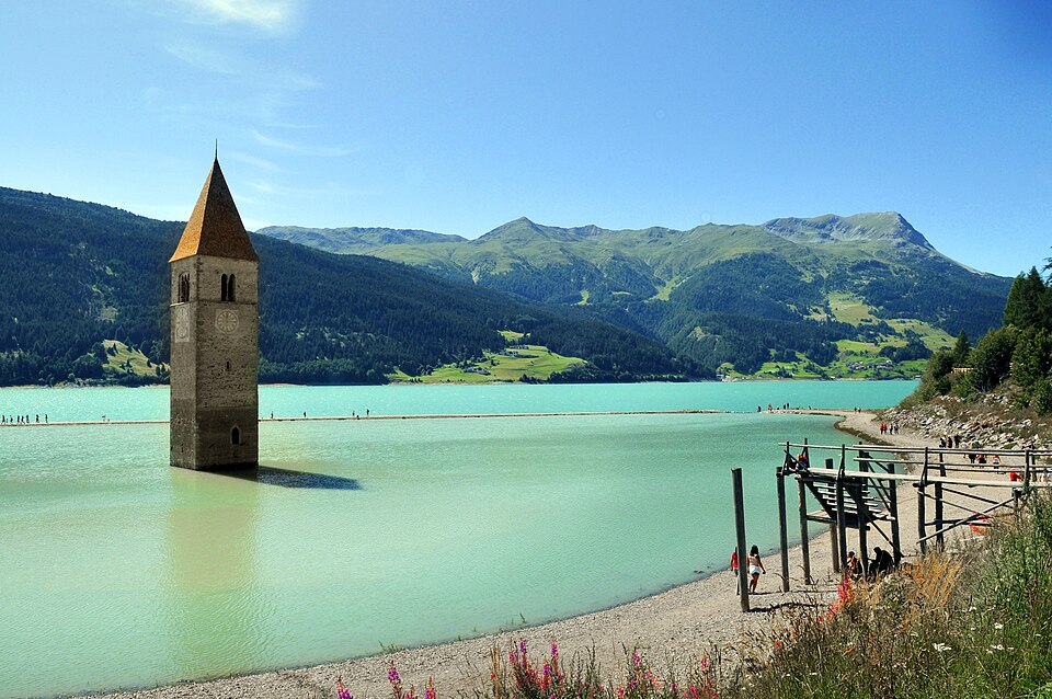 A bell tower poking out of a lake